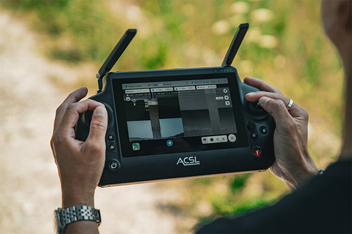 Pilot holding the ACSL TAITEN smart controller